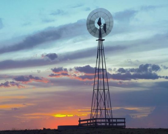 Windmill Producing Electricity at Sunset, an Example of Renewable Energy, North America